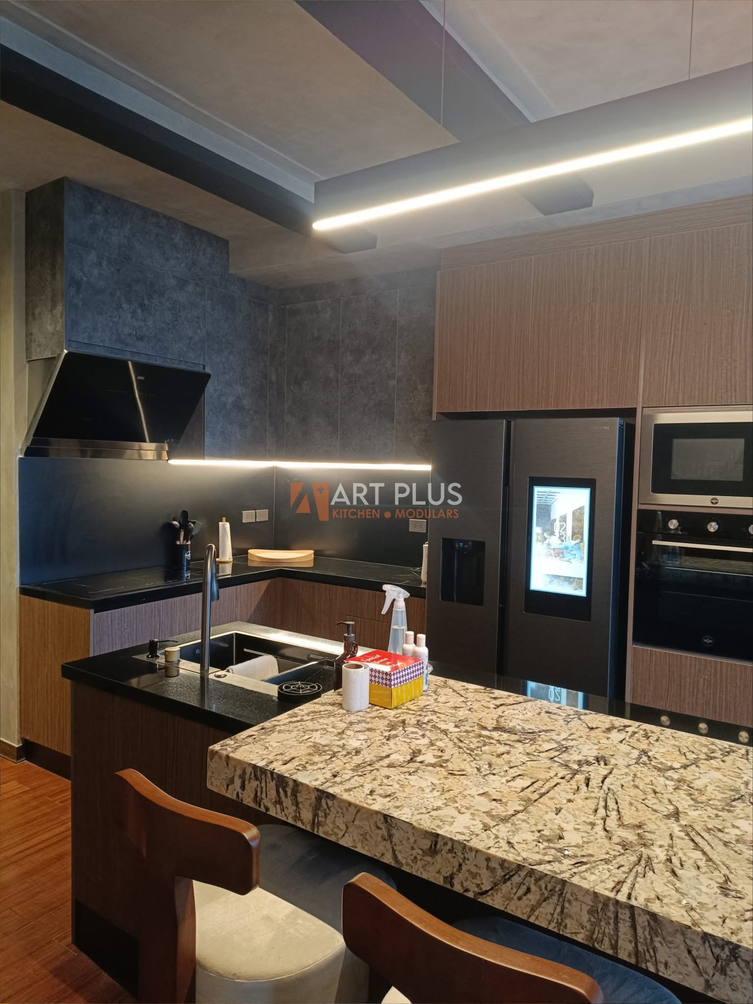 Dark industrial kitchen with wood grain cabinets and granite island