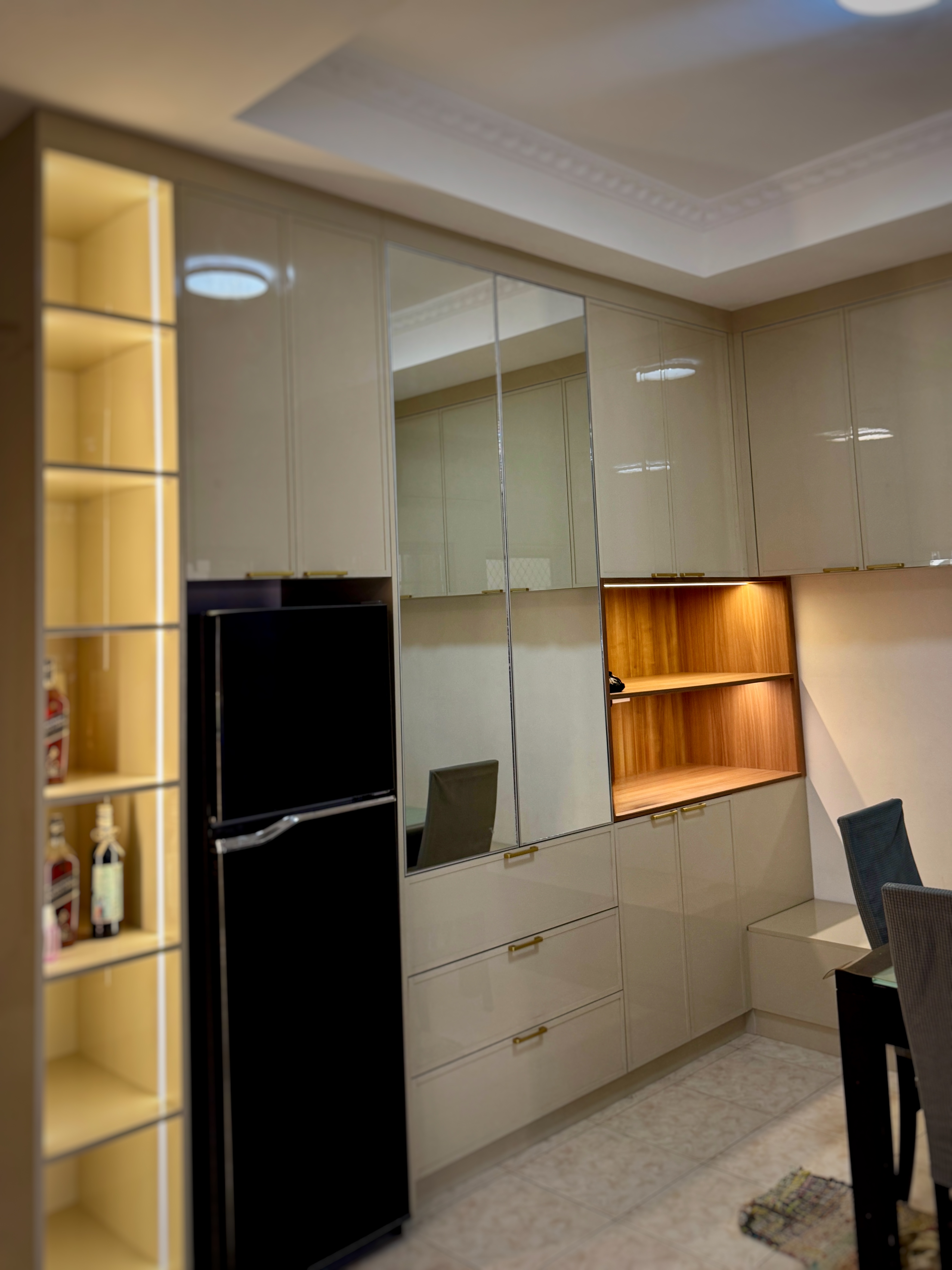 Full cabinet wall with LED bar shelving, mirror panels and walnut accent