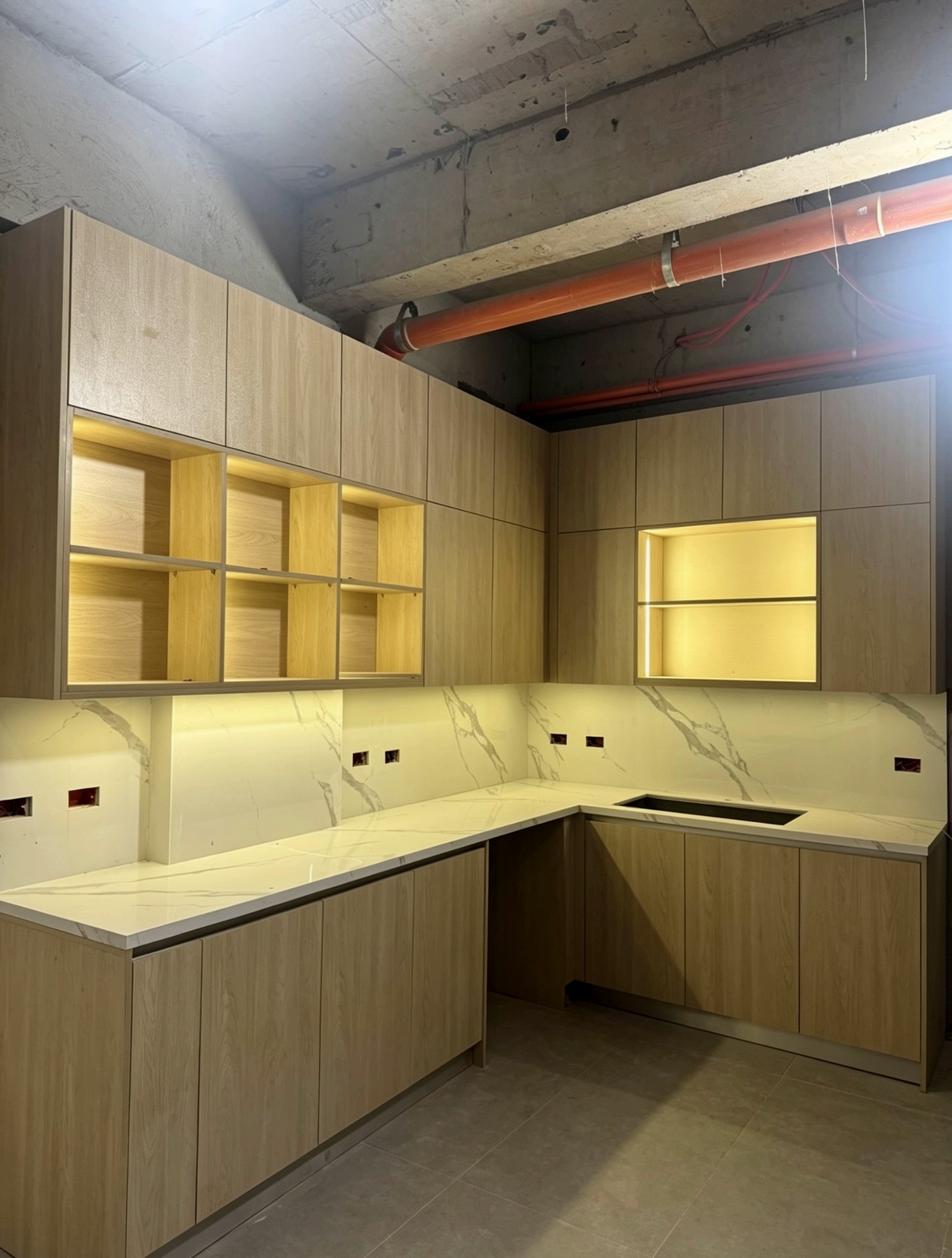 L-shape condo kitchen with wood cabinets, LED open shelving and marble countertop
