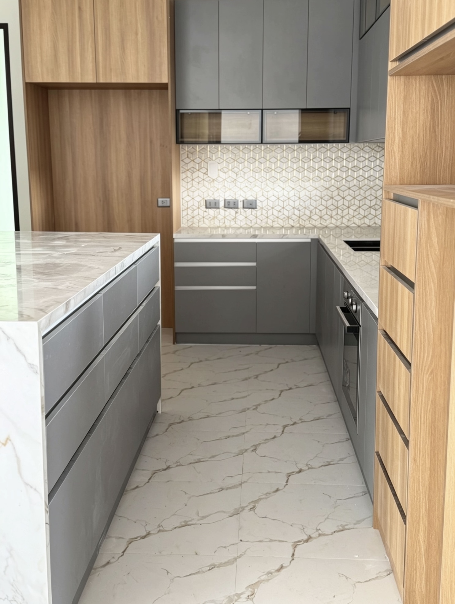 Grey and wood kitchen with geometric tile backsplash and marble floor